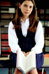 Girl with book in library
